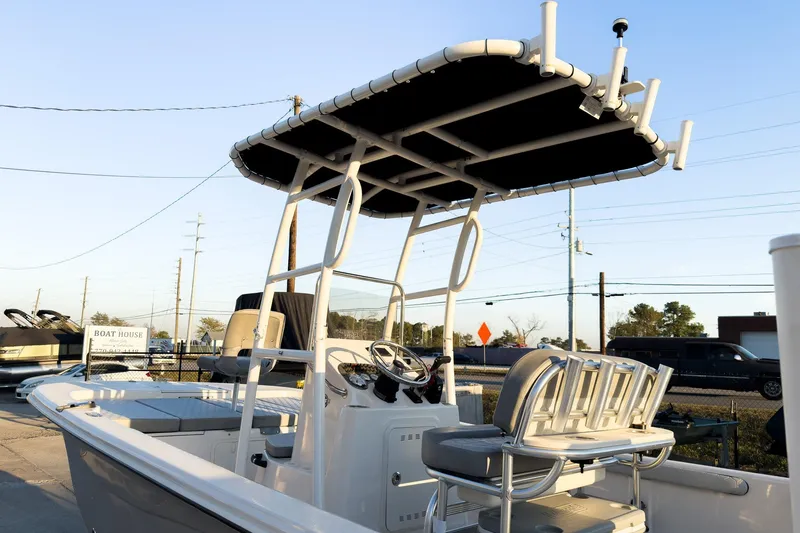 Slide: The Image of 2026 Carolina Skiff 19 LS boat with T-top and seating, displayed outdoors. - 4