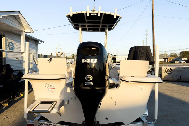 Slide: The Image of 2026 Carolina Skiff 19 LS boat with 140 HP engine, parked outdoors. - 5