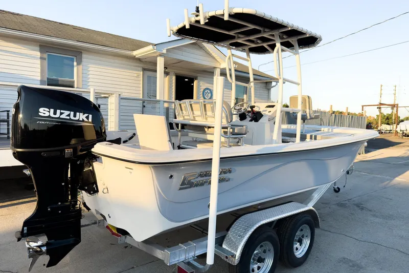 Slide: The Image of 2026 Carolina Skiff 19 LS boat with Suzuki outboard motor on trailer. - 6