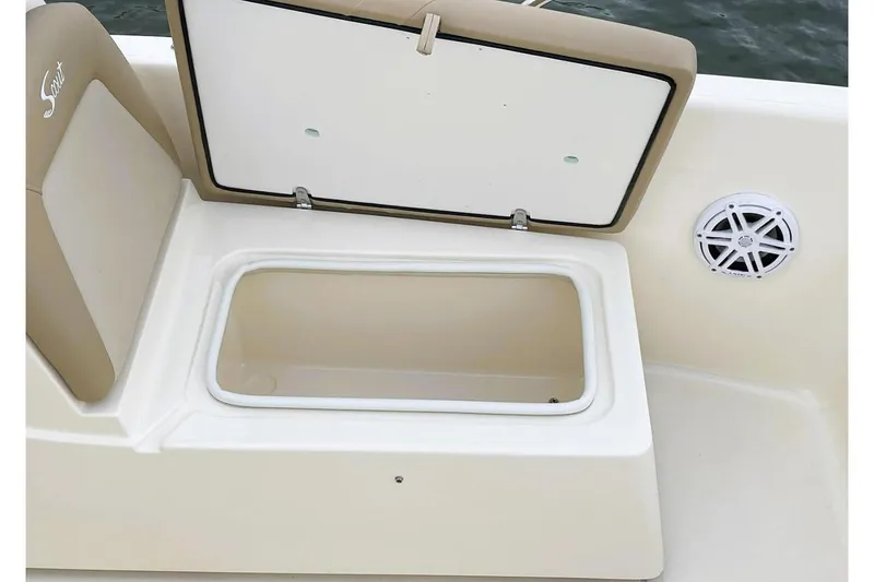 Slide: The Image of Manufacturer Provided Image: 2025 Scout 175 Sport Dorado boat storage compartment with open lid and speaker. - 6