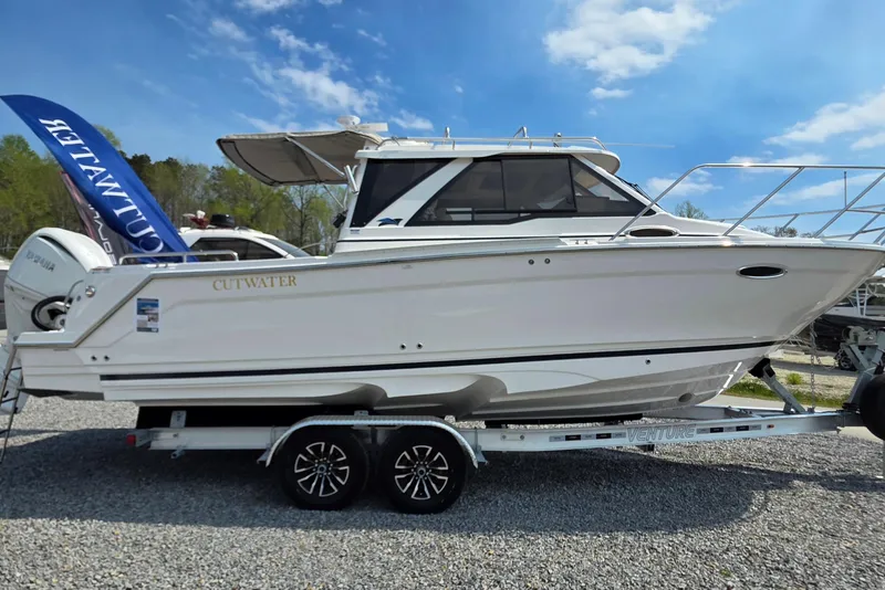 The Image of 2026 Cutwater C-248 Coupe boat on trailer under clear blue sky. - 1