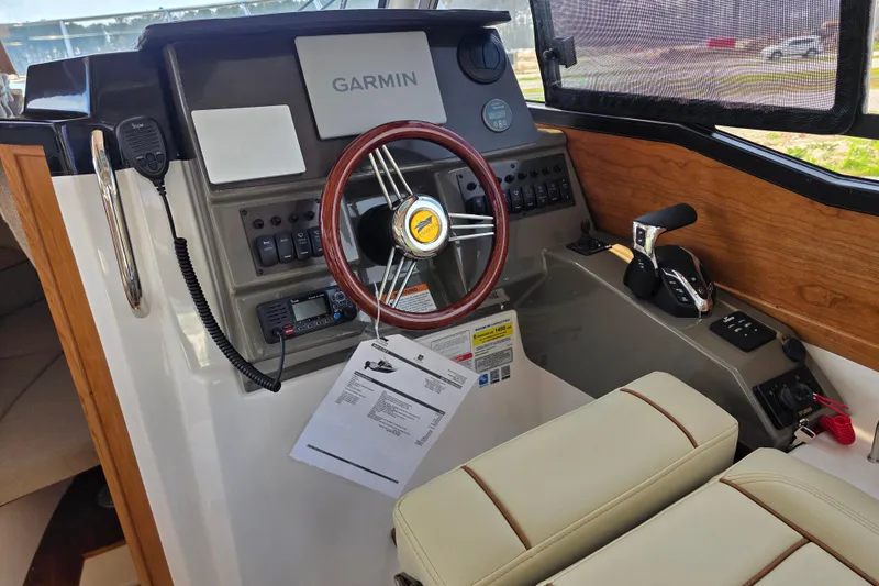 Slide: The Image of 2026 Cutwater C-248 Coupe helm with Garmin navigation, wood accents, and modern controls. - 10