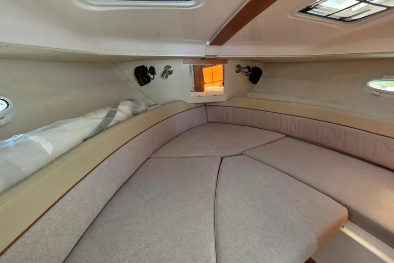 Slide: The Image of 2026 Cutwater C-248 Coupe interior cabin with cozy seating and natural light. - 11