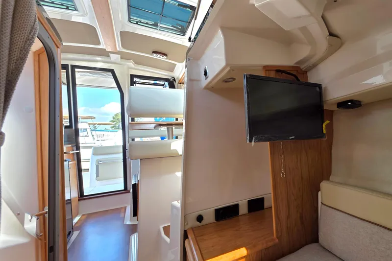 Slide: The Image of Interior of 2026 Cutwater C-248 Coupe boat with seating and mounted TV. - 13