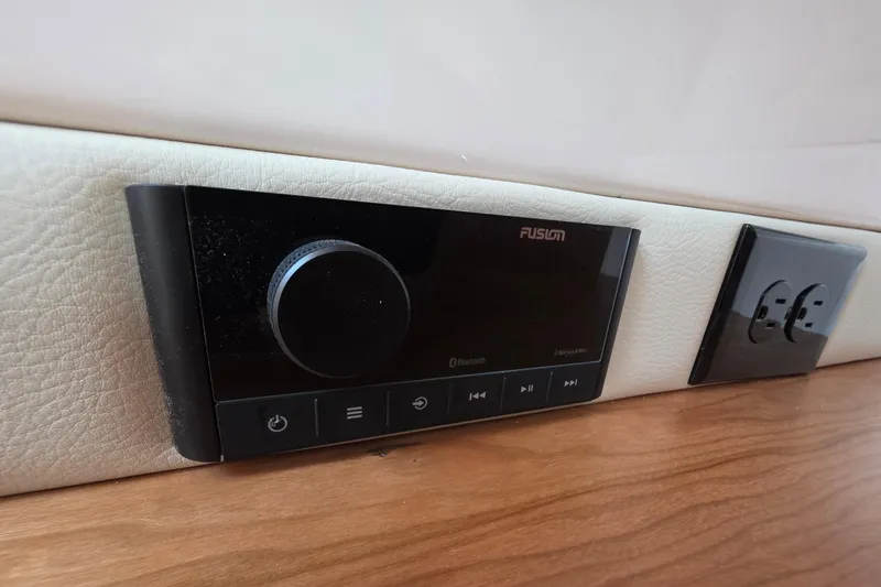 Slide: The Image of Fusion audio system and power outlet in 2026 Cutwater C-248 Coupe interior. - 14