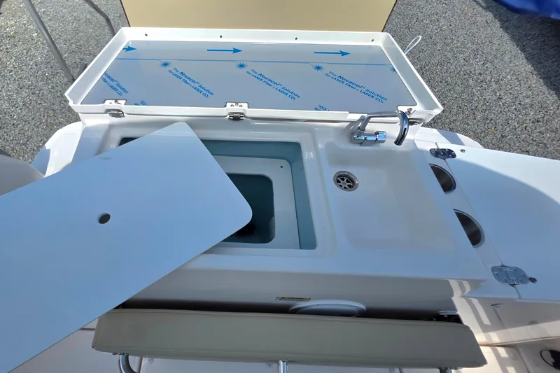 Slide: The Image of 2026 Cutwater C-248 Coupe boat sink and storage area with open lid. - 4