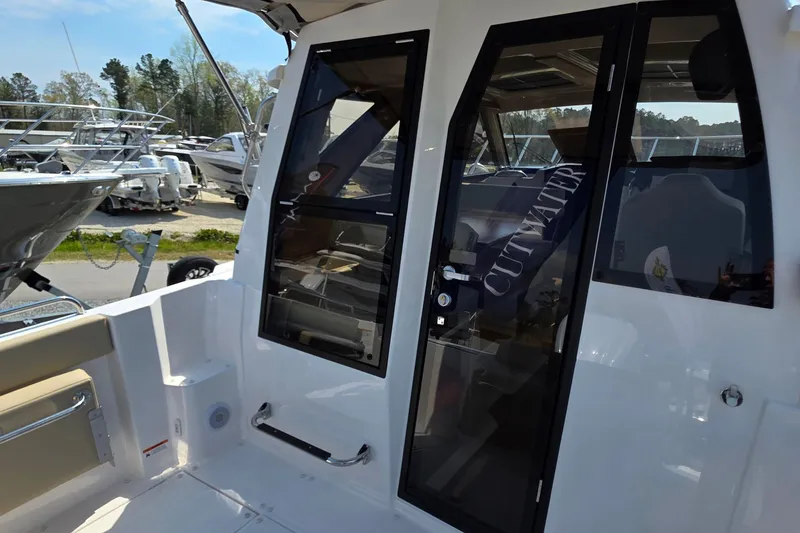 Slide: The Image of 2026 Cutwater C-248 Coupe boat exterior with glass doors and sleek design. - 5