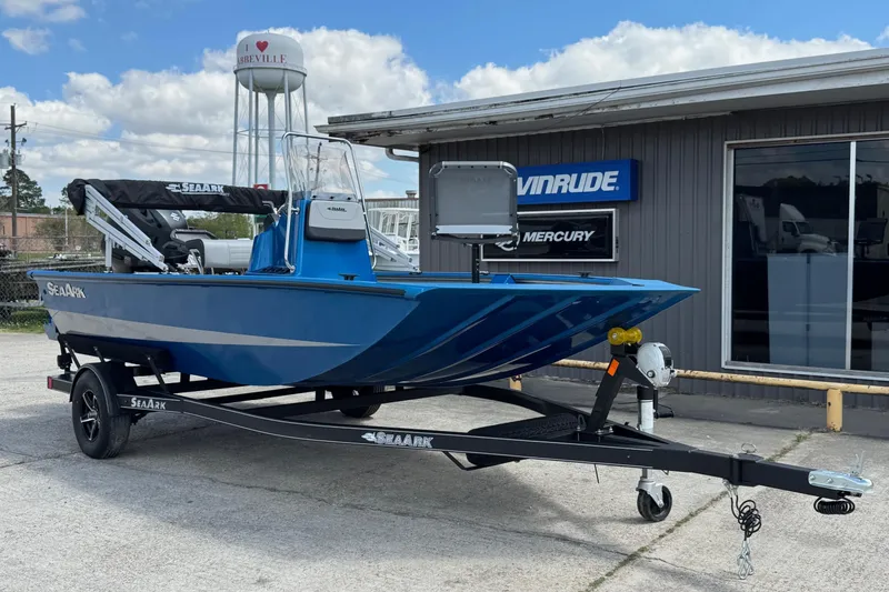 The Image of 2026 SeaArk Shadow 187T boat on trailer, parked outside dealership under blue sky. - 1