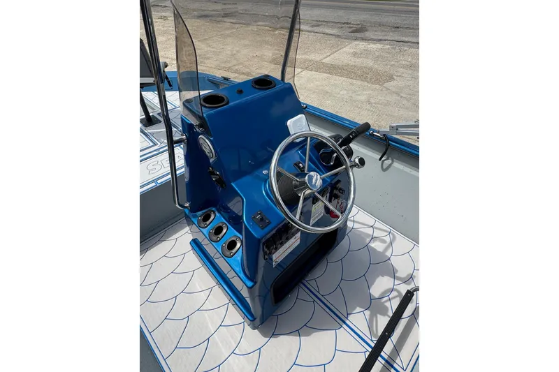 Slide: The Image of Blue console of 2026 SeaArk Shadow 187T boat with steering wheel and controls. - 14