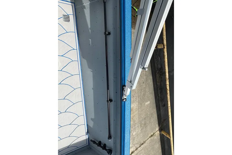 Slide: The Image of 2026 SeaArk Shadow 187T boat interior with rod holder and blue accents. - 15