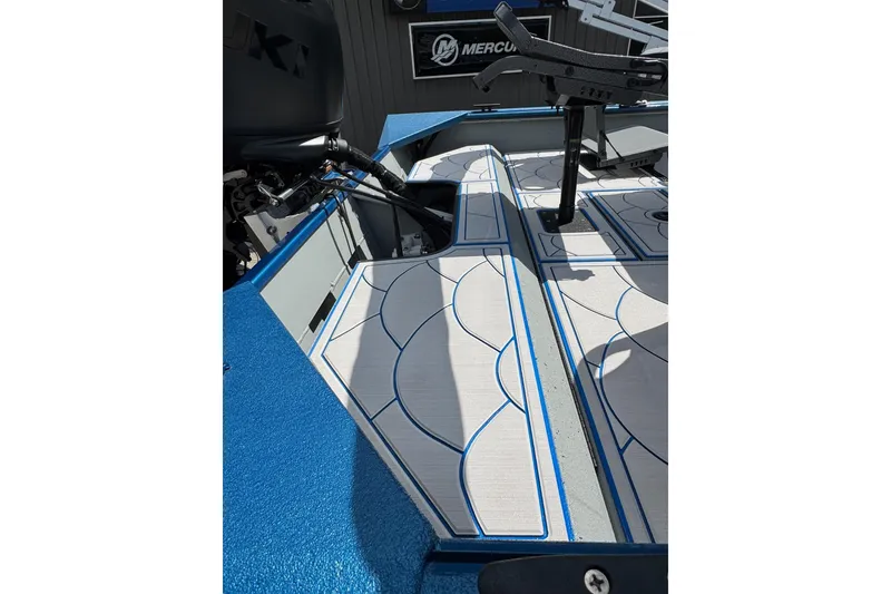 Slide: The Image of 2026 SeaArk Shadow 187T boat interior with blue and gray patterned flooring. - 19