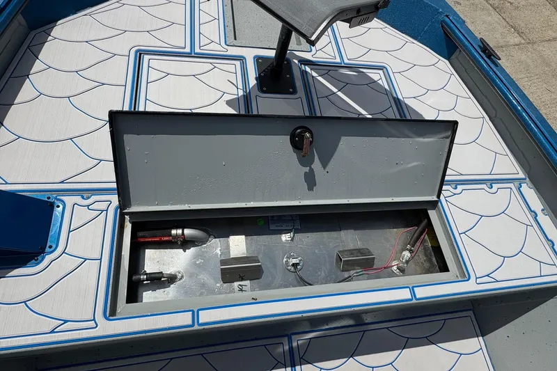 Slide: The Image of Open storage compartment on 2026 SeaArk Shadow 187T boat deck. - 7