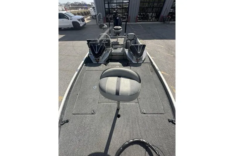 Slide: The Image of 2023 Ranger Z520R fishing boat interior with seating and equipment, parked outdoors. - 13