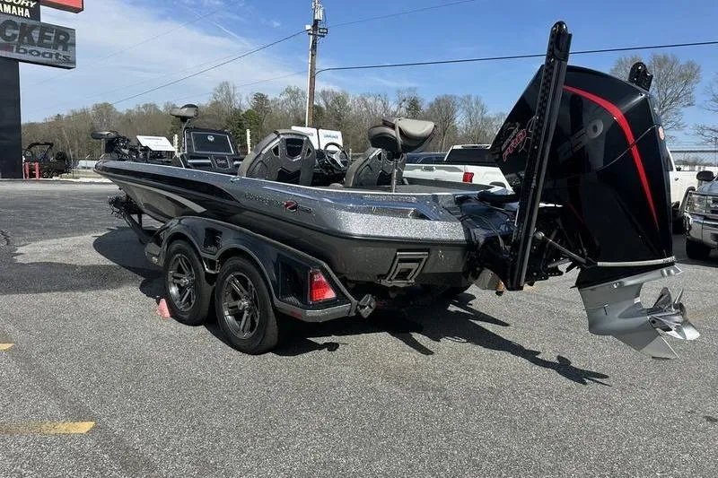 Slide: The Image of 2023 Ranger Z520R boat with powerful outboard motor on trailer in parking lot. - 3