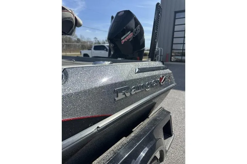 Slide: The Image of 2023 Ranger Z520R boat with metallic finish, parked outdoors near a building. - 5