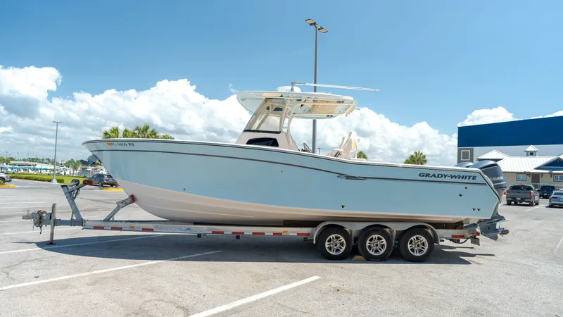 Slide: The Image of 2019 Grady-White Canyon 306 boat parked on trailer outdoors. - 0