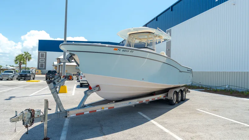Slide: The Image of 2019 Grady-White Canyon 306 boat parked on trailer outdoors. - 1