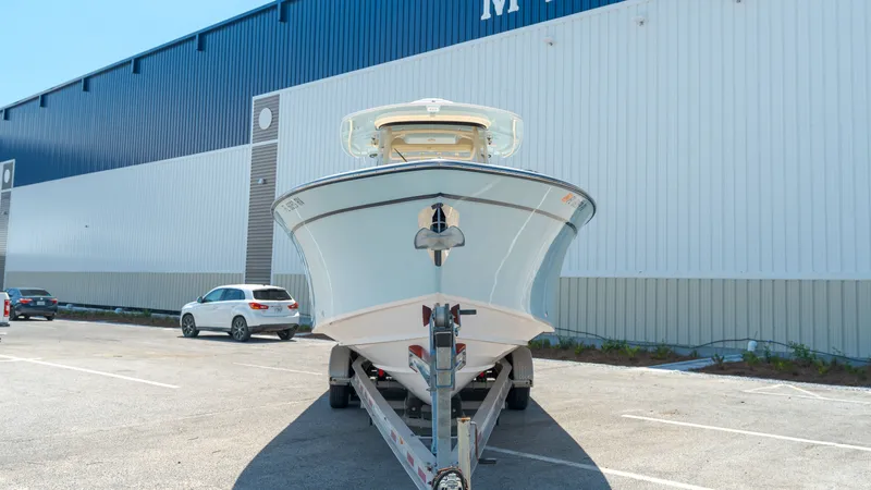 Slide: The Image of 2019 Grady-White Canyon 306 boat on trailer in front of warehouse. - 2