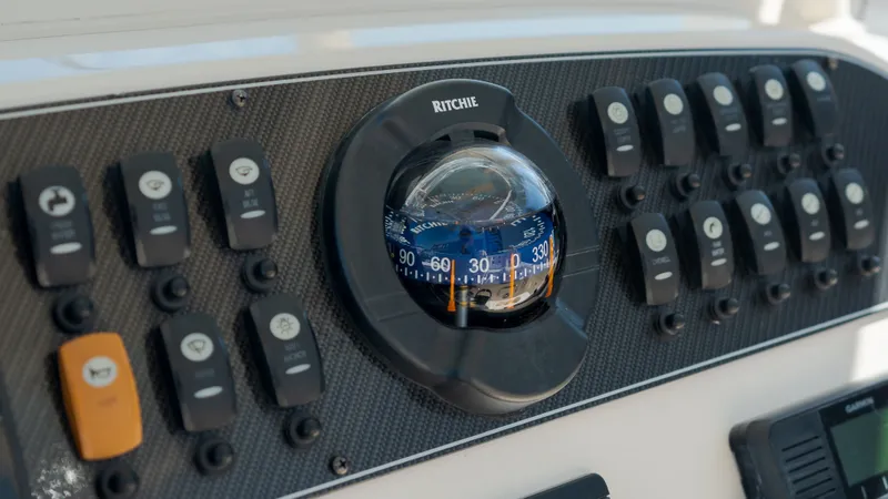 Slide: The Image of Grady-White Canyon 306 2019 compass and switches on dashboard. - 22