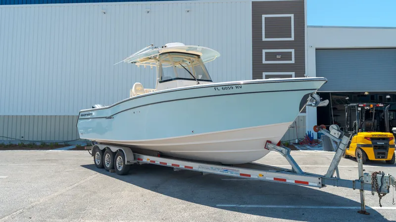 Slide: The Image of 2019 Grady-White Canyon 306 boat on trailer outside warehouse. - 3