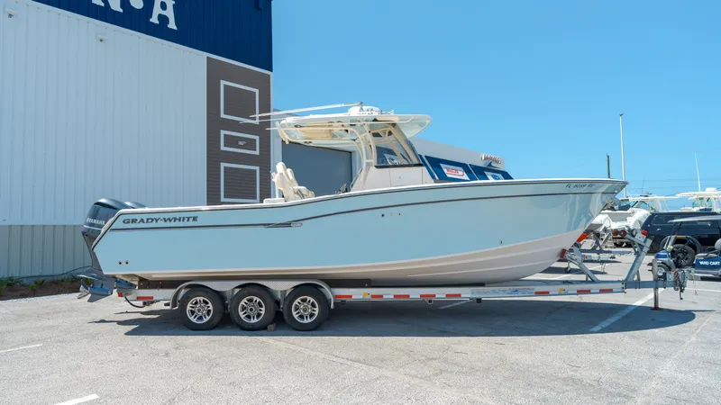 Slide: The Image of 2019 Grady-White Canyon 306 boat on trailer outside warehouse. - 4