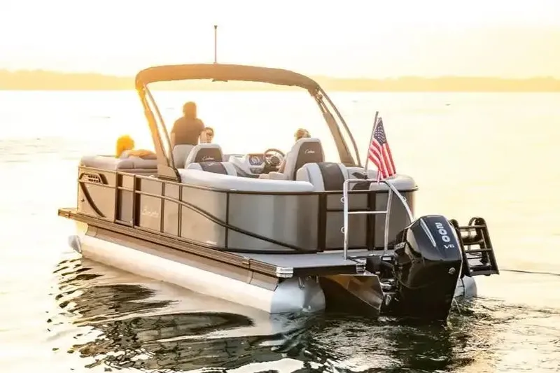 Slide: The Image of Manufacturer Provided Image: 2026 Barletta Cabrio 22QC pontoon boat on water at sunset with passengers. - 2