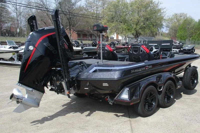 Slide: The Image of 2025 Ranger Z520R boat with powerful outboard motor, sleek design, and dual-axle trailer. - 2