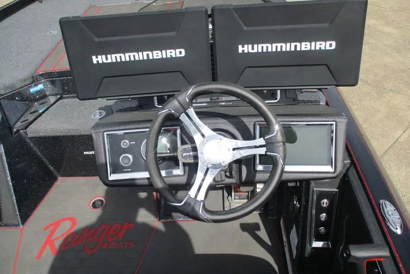 Slide: The Image of 2025 Ranger Z520R boat dashboard with dual Humminbird displays and steering wheel. - 7