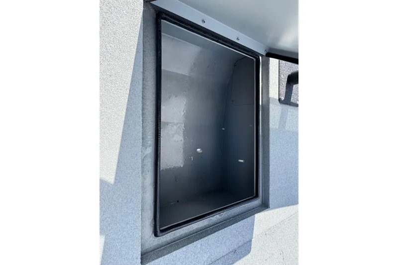 Slide: The Image of Open storage compartment on 2025 SeaArk Shadow 18T boat. - 11