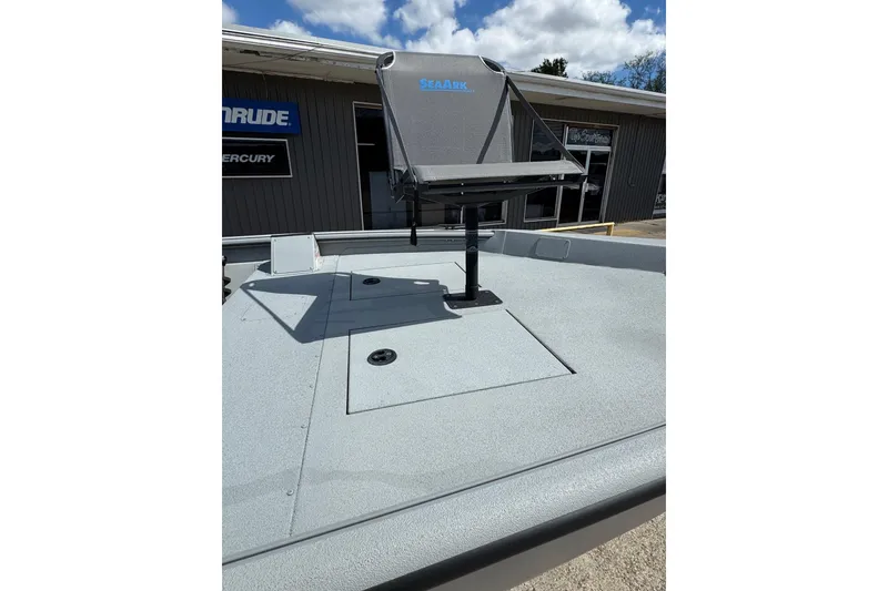 Slide: The Image of 2025 SeaArk Shadow 18T boat deck with mounted seat, displayed outdoors. - 14