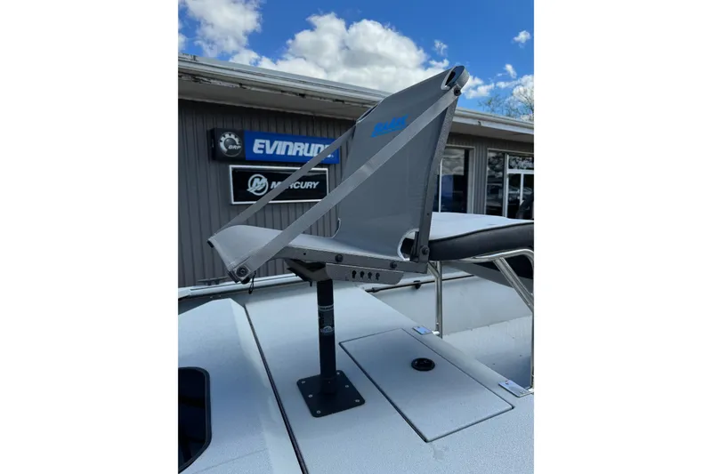 Slide: The Image of 2025 SeaArk Shadow 18T boat seat with Evinrude and Mercury signage in background. - 21