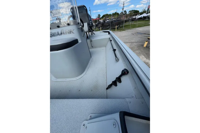 Slide: The Image of 2025 SeaArk Shadow 18T boat interior with steering console and equipment. - 22