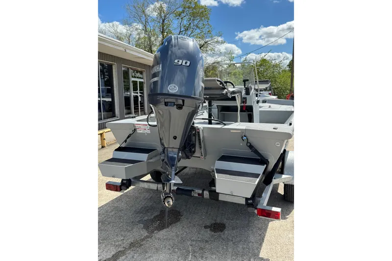 Slide: The Image of 2025 SeaArk Shadow 18T boat with Yamaha 90 engine, parked outdoors. - 3