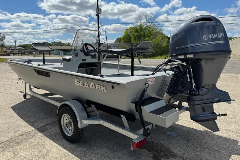 Slide: The Image of 2025 SeaArk Shadow 18T boat with Yamaha engine on trailer, parked outdoors. - 4