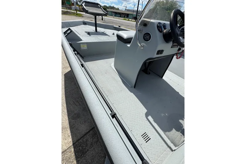 Slide: The Image of 2025 SeaArk Shadow 18T boat interior with steering console and seating. - 6