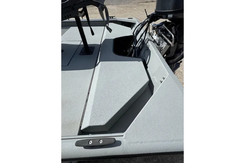 Slide: The Image of 2025 SeaArk Shadow 18T boat deck with motor and seating area. - 7