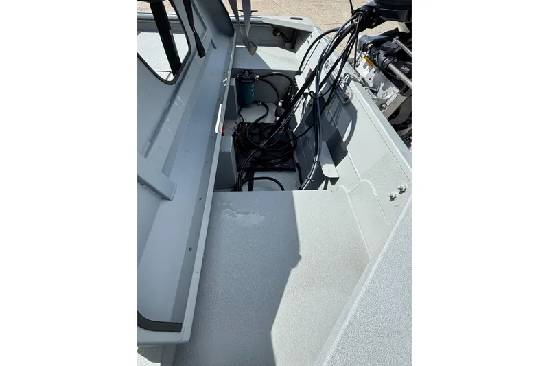 Slide: The Image of 2025 SeaArk Shadow 18T boat interior showing engine compartment and wiring. - 8