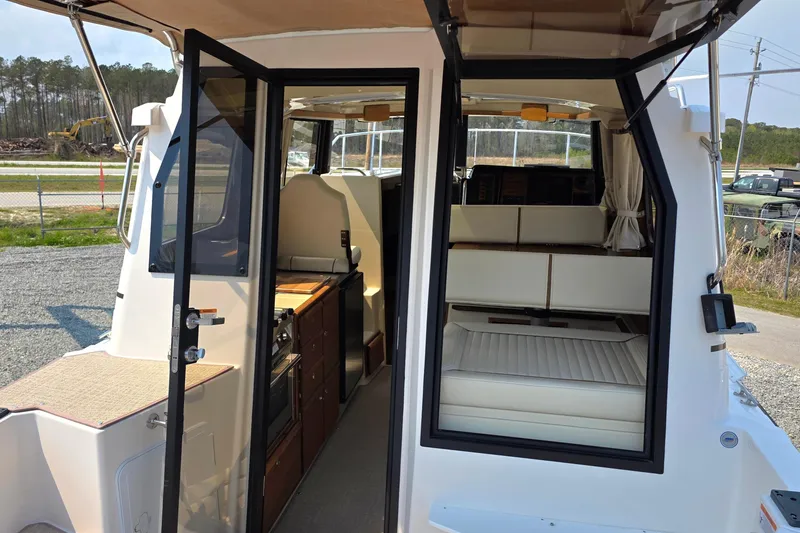 Slide: The Image of Interior view of 2026 Ranger Tugs R-27, showcasing cabin and seating area. - 10