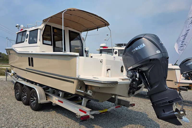 Slide: The Image of 2026 Ranger Tugs R-27 boat on trailer with Yamaha outboard motor. - 2