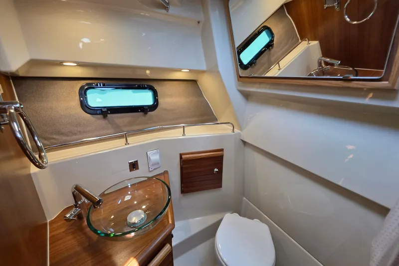 Slide: The Image of 2026 Ranger Tugs R-27 boat bathroom with modern fixtures and elegant design. - 22