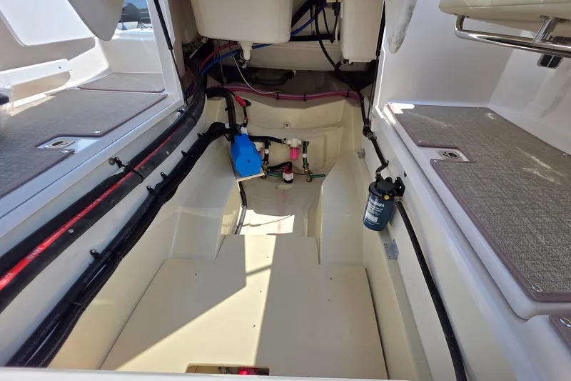 Slide: The Image of Interior view of 2026 Ranger Tugs R-27 boat showing engine compartment details. - 25