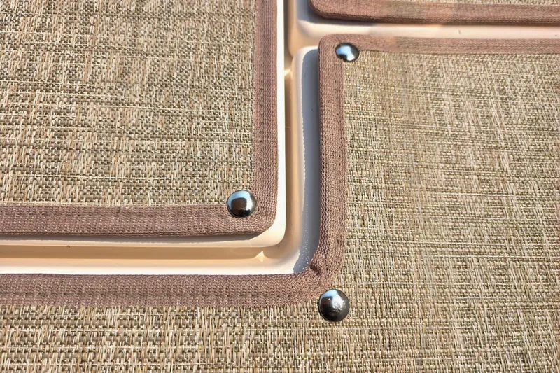 Slide: The Image of Close-up of textured fabric with metal rivets on a 2026 Ranger Tugs R-27. - 5