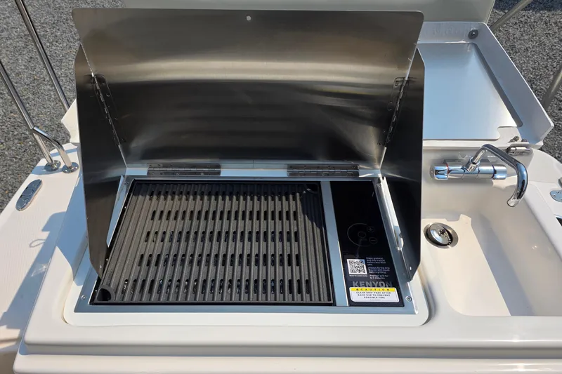 Slide: The Image of Outdoor grill and sink on 2026 Ranger Tugs R-27 boat deck. - 6