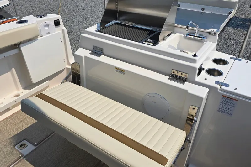 Slide: The Image of 2026 Ranger Tugs R-27 boat interior with grill, sink, and seating area. - 7