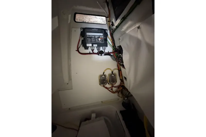 Slide: The Image of Electrical wiring and components inside a 2026 Sportsman Open 232 Center Console boat. - 13