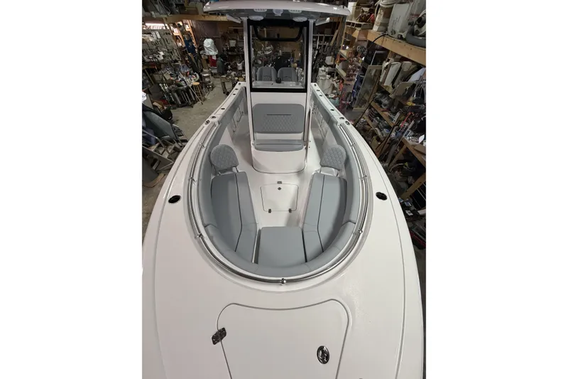 Slide: The Image of 2026 Sportsman Open 232 Center Console boat interior with seating and console view. - 17
