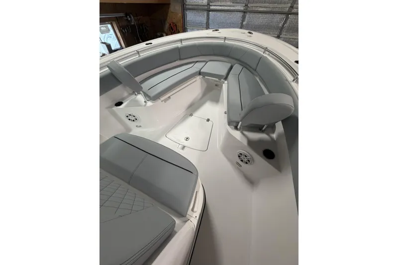 Slide: The Image of 2026 Sportsman Open 232 Center Console boat interior with cushioned seating and storage compartments. - 19