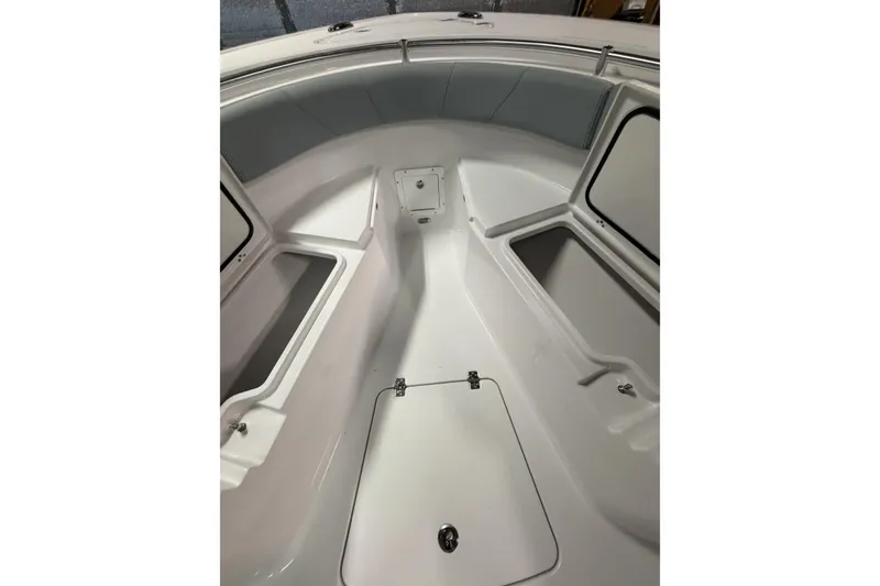 Slide: The Image of 2026 Sportsman Open 232 Center Console boat interior with storage compartments and seating. - 22