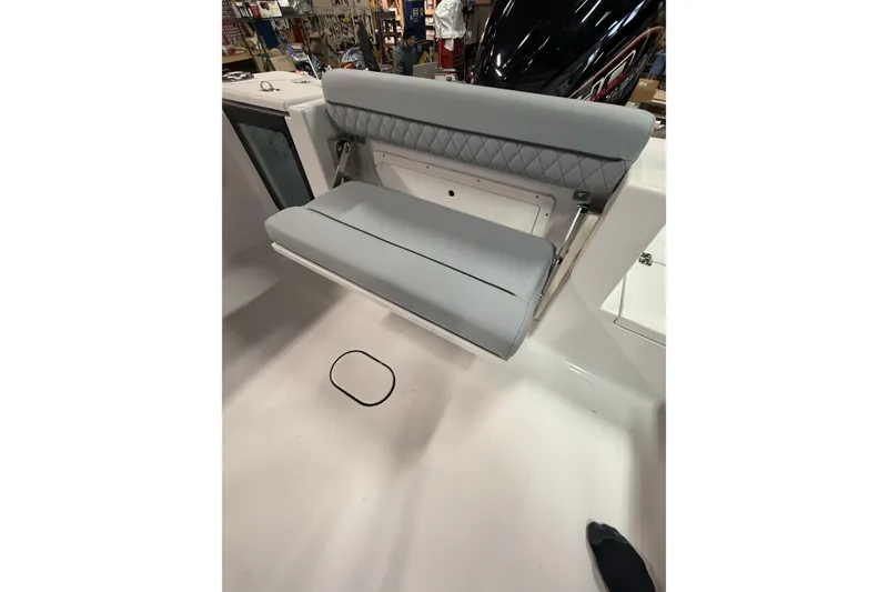 Slide: The Image of 2026 Sportsman Open 232 Center Console boat with foldable gray seating. - 29