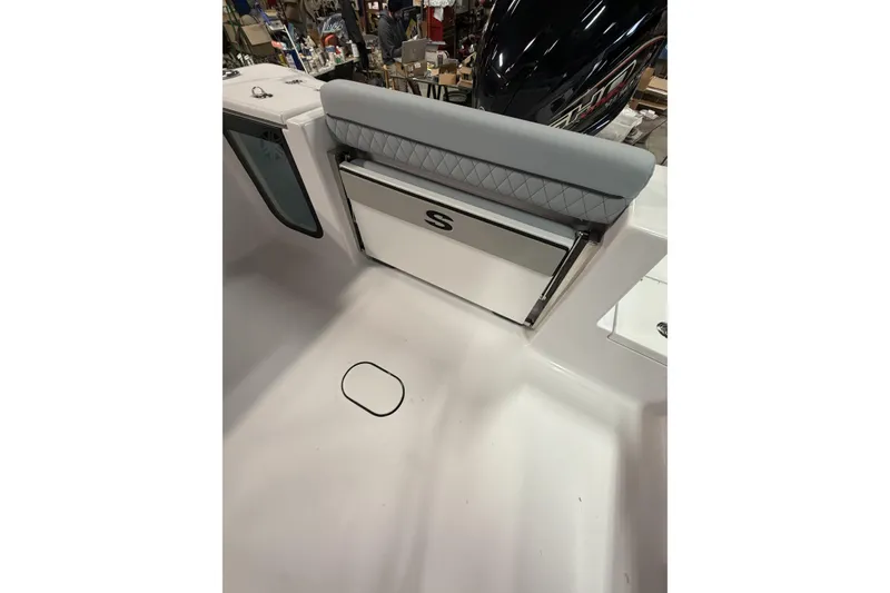 Slide: The Image of 2026 Sportsman Open 232 Center Console boat interior with cushioned seating and storage. - 30